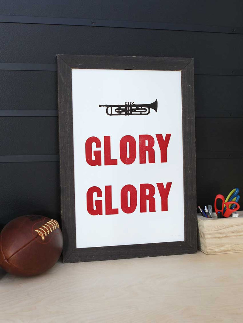 Glory Glory print next to a football and a cup of office supplies