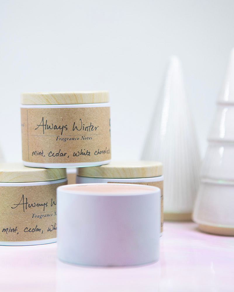 Collection of candles with visible branding on a light background