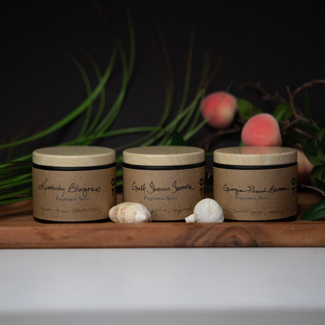 Three jars with labels on a wooden surface with a dark background